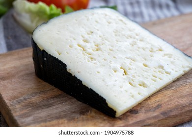 Cheese collection, French fol epi cheese with many little holes, etorki, tomme noire des pyrenees and ossau iraty cheeses close up - Powered by Shutterstock