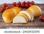 Cheese collection, Italian cheese scamorza, caciocavallo, provolone made from cow milk in South Italy yellow smoked cheese close up