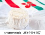 Cheese collection, soft sheeps milk brebis French cheese with mold produced on cheese farm in Basque Country in France and towel with Basque symbols and colours