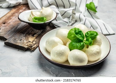 Cheese Collection, White Balls Of Soft Italian Cheese Mozzarella, Served With Fresh Basil Leaves On A Light Background, Place For Text, Top View,