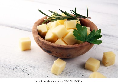 Cheese Cubes In Wooden Bowl With Parsley. Cheese Pieces