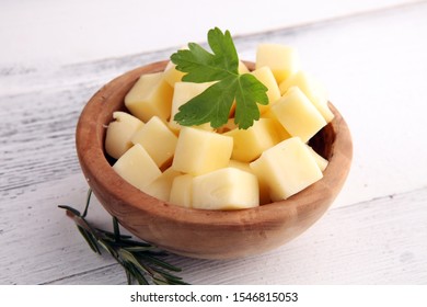 Cheese Cubes In Wooden Bowl With Parsley. Cheese Pieces