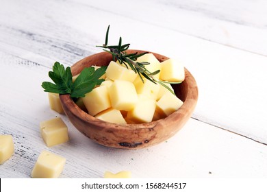 Cheese Cubes In Wooden Bowl With Parsley. Cheese Pieces