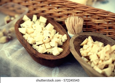 Cheese cubes in a wooden plate  - Powered by Shutterstock