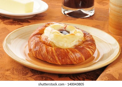 A Cheese Danish With Jam And Coffee