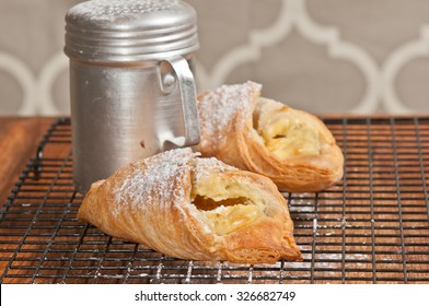 Cheese Danish And Powdered Sugar Shaker On Cooling Screen