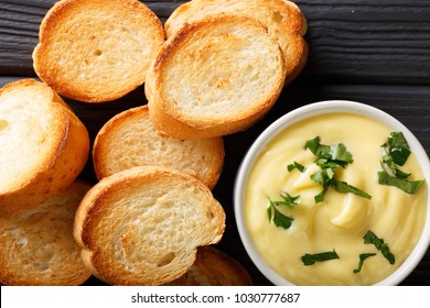 Cheese Dip Sauce With Toasted Bread Close-up On The Table. Horizontal Top View From Above
