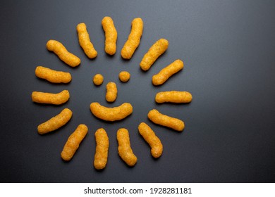 Cheese Doodle Day, Cheese puffs flat lay, symbol of the sun, crisps