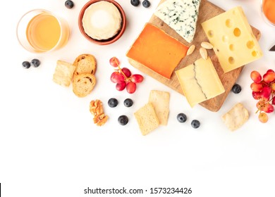 Cheese, A Flat Lay Overhead Shot On A White Background With Copy Space. Blue Cheese, Leicester, Emmental, And Others Sorts With Wine, Fruits, Nuts, And A Place For Text