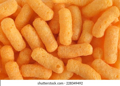 Cheese flavored puffed corn snacks