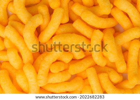 Cheese flavored puffed corn snacks isolated on white background.