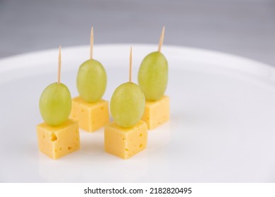 Cheese And Grape Canapes On White Plate Or Background Closeup,snack Concept. 