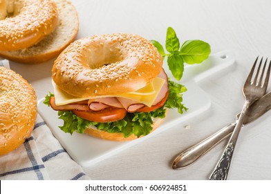 Cheese And Ham Sandwich On Bagel With Salad And Tomato Close-up