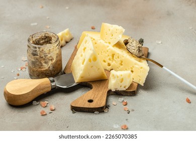 cheese with holes and mushrooms sauce, truffle paste on a wooden board. banner, menu, recipe place for text, top view.
