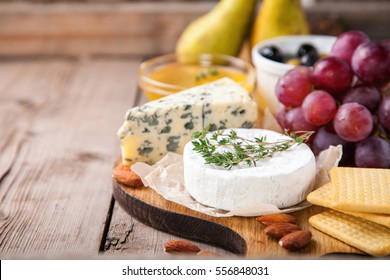 Cheese, honey and fruit on a table. Selective focus.  Copy space. - Powered by Shutterstock