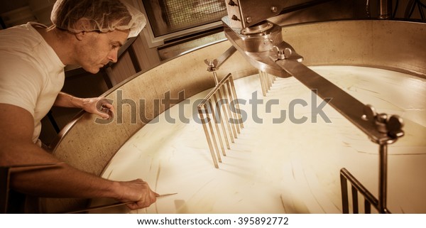 Cheese\
maker -Traditional cheese making at a\
creamery,