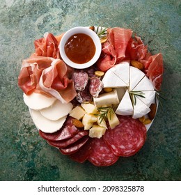 Cheese And Meat Platter With Nuts And Dried Fruits