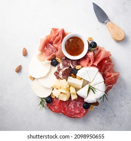 Cheese and meat platter with nuts and dried fruits