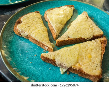 Cheese On Toast With Seeded Granary Bread Cut On A Turquoise Plate