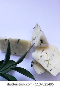 Cheese On White Background With Italian Ruscus Leaves