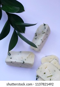 Cheese On White Background With Italian Ruscus Leaves