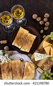 Cheese pie, strudel with cheese, cheese pie 4. Wine, grapes, nuts, cheese, blue cheese, and coffee. dinner, lunch, romantic date, picnic, eating on nature. - Shutterstock ID 421198780