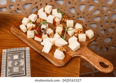 a cheese plate with gouda cheese brie blue cheese walnuts grapes - Powered by Shutterstock