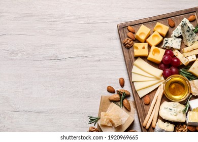 Cheese plate with honey, grapes and nuts on white table, flat lay. Space for text - Powered by Shutterstock