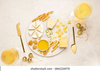 Cheese Plate On Marble Board, White Wine And Holiday Decorations