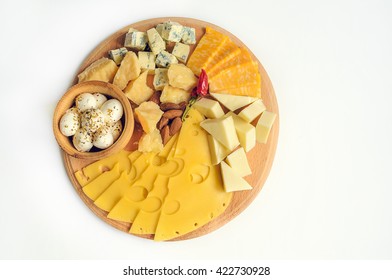 Cheese plate: Parmesan, cheddar, gouda, mozzarella and other with chili pepper and almonds on wooden board. Tasty appetizers. Isolated. Top view.