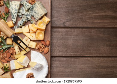 Cheese plate with rosemary and nuts on wooden table, top view. Space for text - Powered by Shutterstock