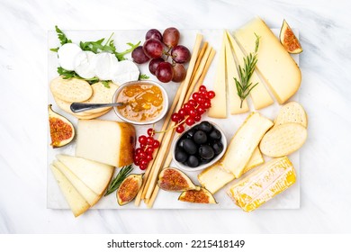 cheese plate with soft and hard cheeses brie, camembert, pecorino, goat cheese with jam olives and grissini and crackers. Italian and French cheeses - Powered by Shutterstock