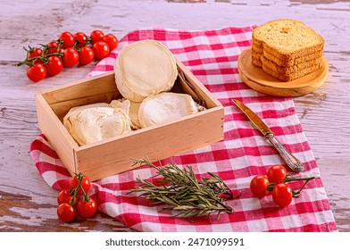 Cheese Platter with Bread, Cherry Tomatoes, and Herbs on Checkered Cloth and Wooden Surface - Powered by Shutterstock