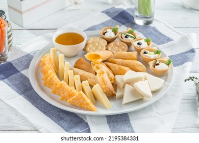 Cheese platter with different cheese and honey Festive gourmet appetizer on the table side view