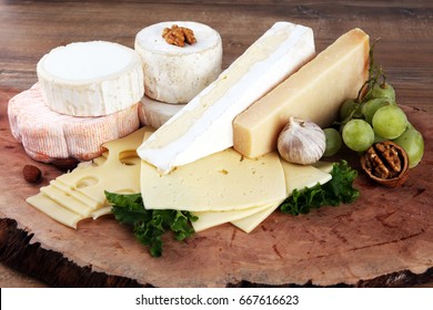 Cheese platter with different cheese on brown wood - Powered by Shutterstock