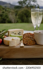 Cheese Platter On Table With Champagne Bottle And Glasses