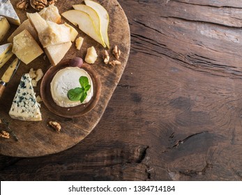 Cheese Platter With Organic Cheeses, Fruits, Nuts On Wooden Table. Top View.