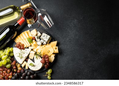 Cheese platter and red wine on black background. - Powered by Shutterstock