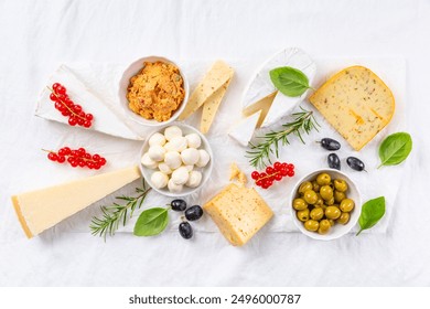 Cheese platter, variation of antipasti and appetizers on white table - Powered by Shutterstock