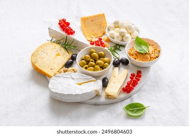 Cheese platter, variation of antipasti and appetizers on white table - Powered by Shutterstock