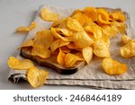 Cheese Potato Chips on a Wooden Board, side view.