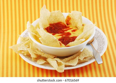 Cheese And Potato Soup With Tortillas And Salsa Added To Create The Hispanic Or Mexican Accent.  Chili Con Queso Dip With Tortilla Chips.
