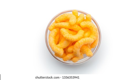 Cheese puffs in a glass bowl, Isolated on a white background. Top view.