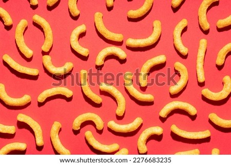 Cheese puffs on red background