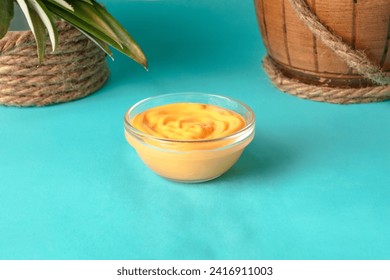 Cheese sauce in glass bowl. Yellow Creamy sauce cheddar or thousand islands in transparent cup, Yellow sauce. Fast food concept - Powered by Shutterstock