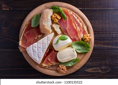 Cheese Selection On Wooden Rustic Background. Cheese Platter With Different Cheeses, Jamon Or Prosciutto. View From Above, Top Studio Shot