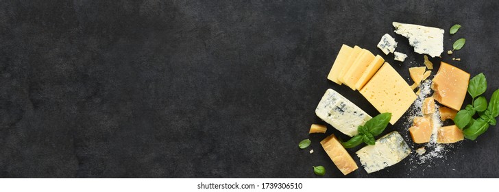 Cheese Set: Brie, Blue Cheese, Parmesan And Basil On A Black Concrete Background. View From Above.