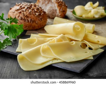 Cheese Slices And Bread On Wooden Table