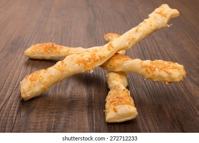 Cheese Sticks With Flaky Pastry On A Wooden Board