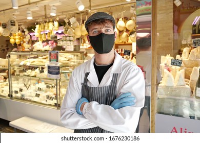 A Cheese Store Clerk With A Covid-19 Protective Mask. Milan, Italy - March 2020